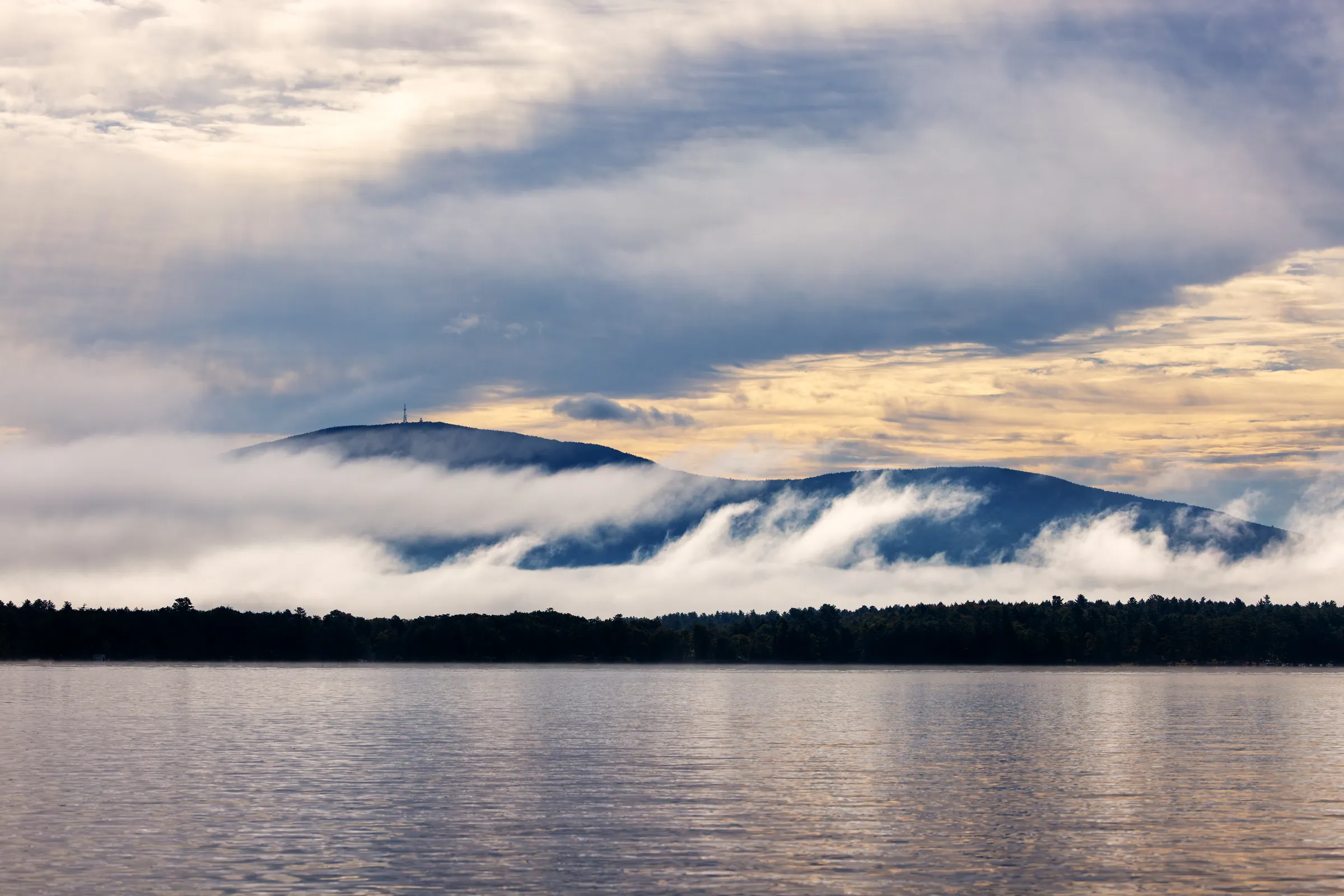 Pleasant Lake with mountains and low clouds